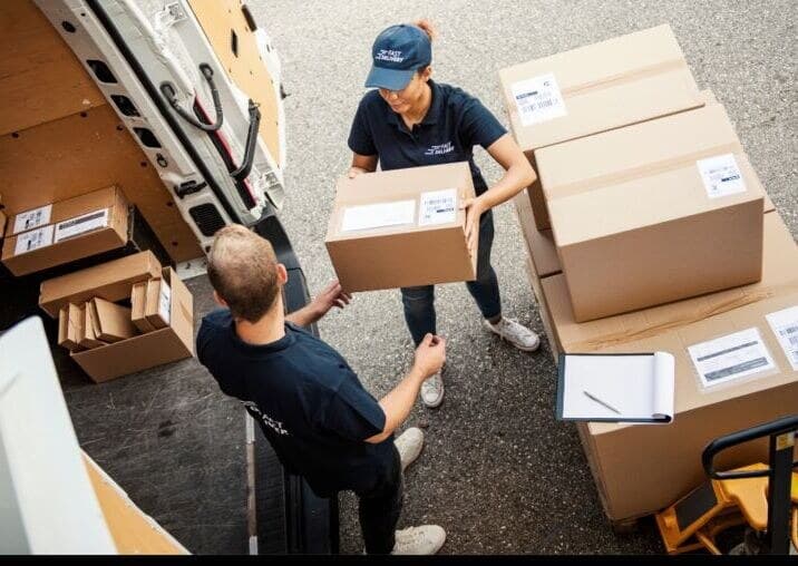 A delivery driver handing over goods at a shop